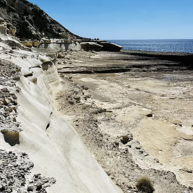 A rocky plateau with wavy surfaces overlooking the sea at Il-Blata tal-Melh.