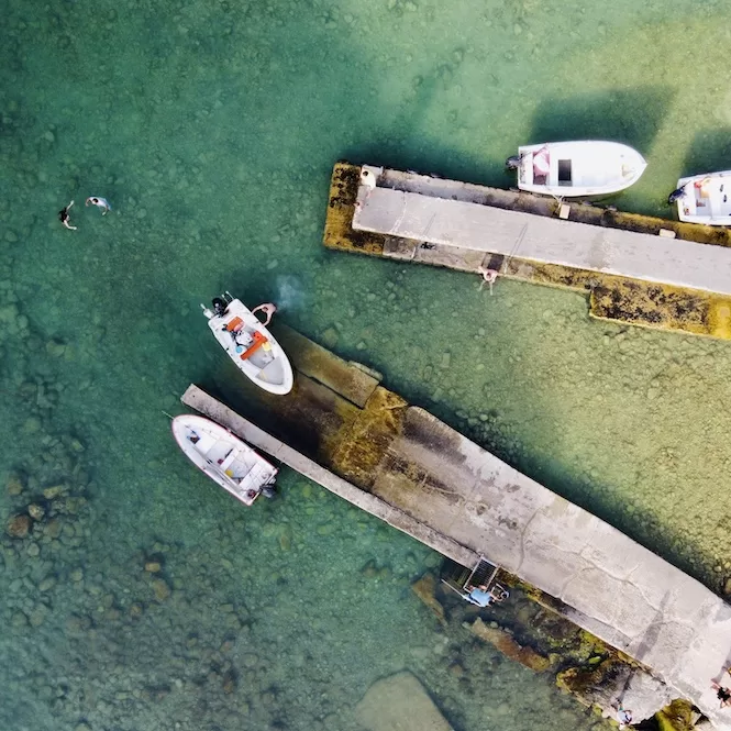 Inland Sea in Gozo - Fishermen Boats and-People Swimming