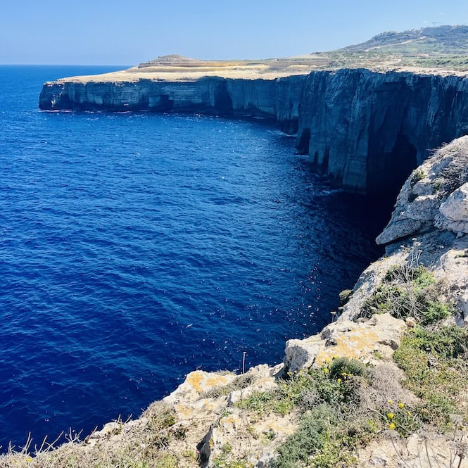 Rugged cliffs dotted with caves along the hike from Wied il-Mielaħ to Ghasri Valley.