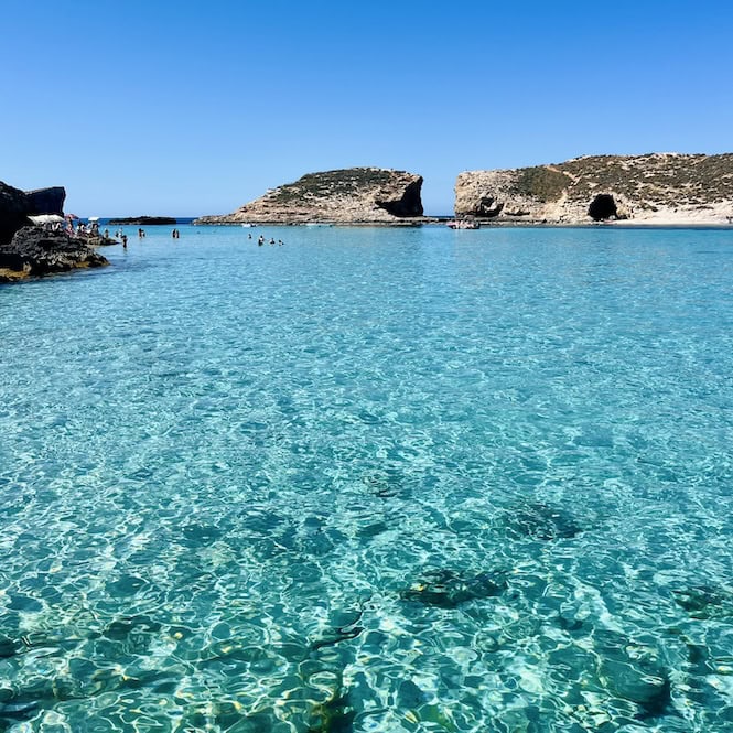 Crystal clear turquoise waters and rocky cliffs at the Blue Lagoon in Comino, Malta