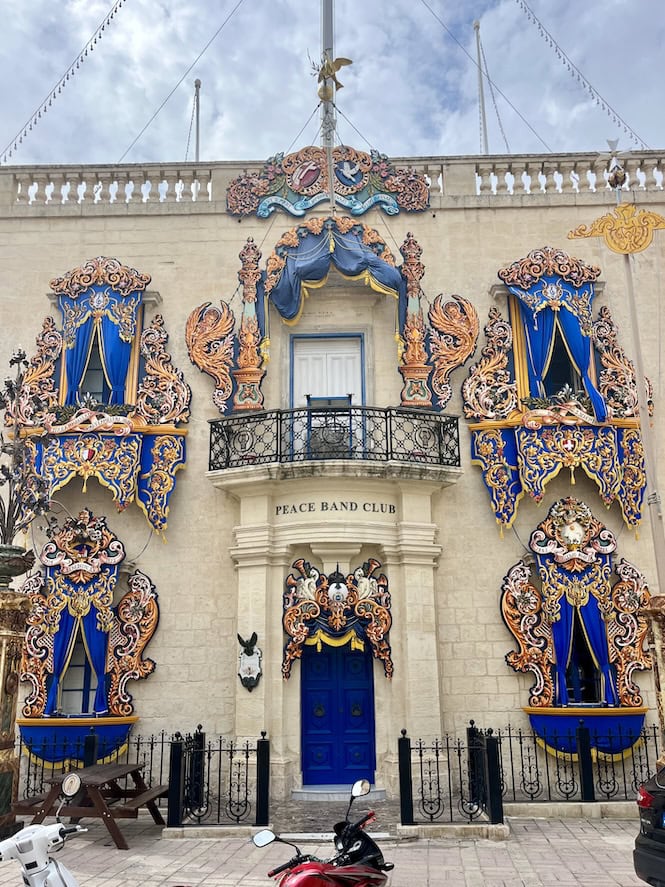 Ornate facade of the Peace Band Club building in Naxxar, Malta, decorated for the Victory Day feast in September.