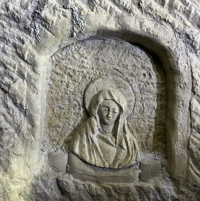 A religious figurine of Saint Mary carved out of limestone, found in Underground Valletta.