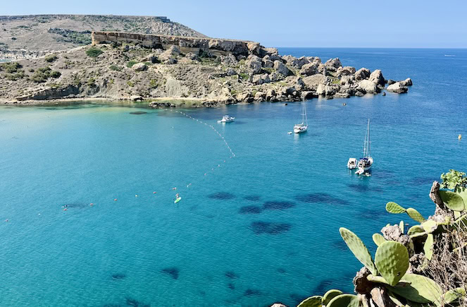 A stunning turquoise Golden Bay surrounded by rocky cliffs in Malta, perfect for visiting in September.