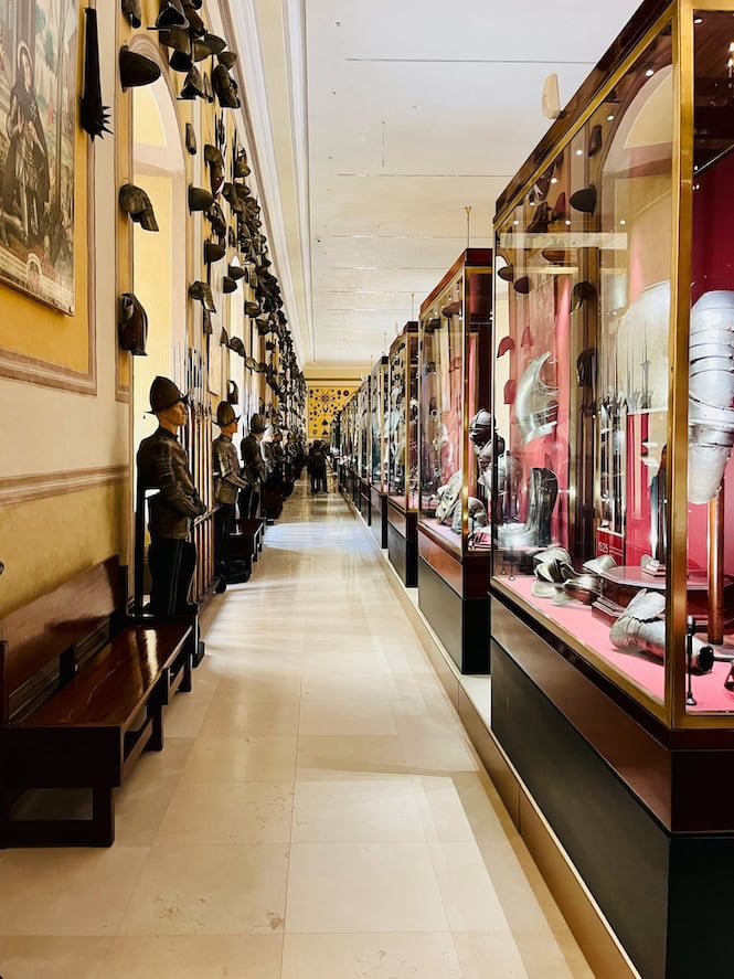 A hallway lined with armour display cases at the Grandmaster's Palace in Valletta, Malta.