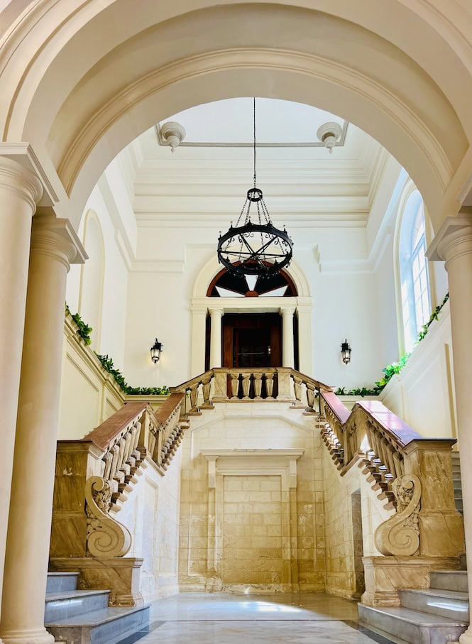 An ornate double staircase at the Grandmaster's Palace in Valletta, Malta.