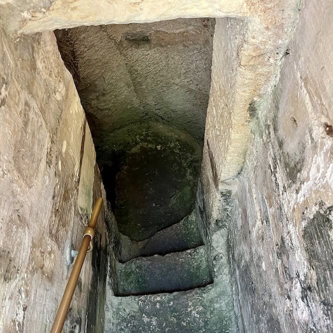 Narrow stone stairway descending into a World War II shelter beneath Casa Rocca Piccola in Valletta, Malta