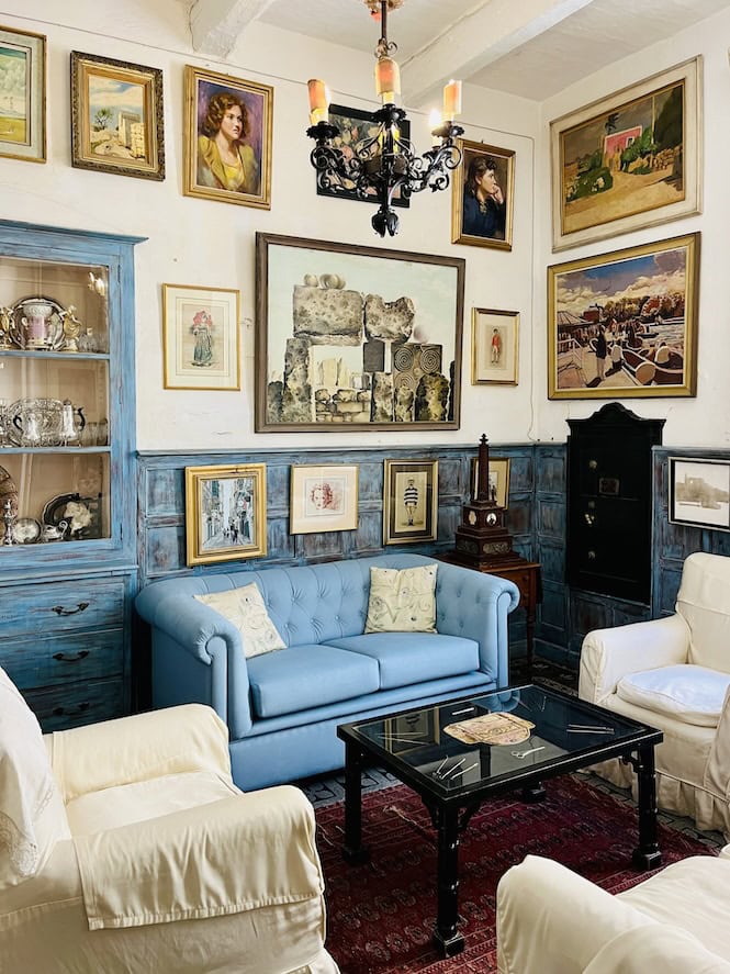 Eclectic living room with artworks and antiques at Casa Rocca Piccola, Valletta.