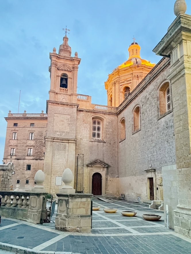 An image of the Basilica of St. Paul in Rabat, Malta, captures its impressive baroque architecture with a grand facade and ornate details. This area is one of the best places to stay in Malta for history enthusiasts, as Rabat is rich in historical sites and cultural heritage.