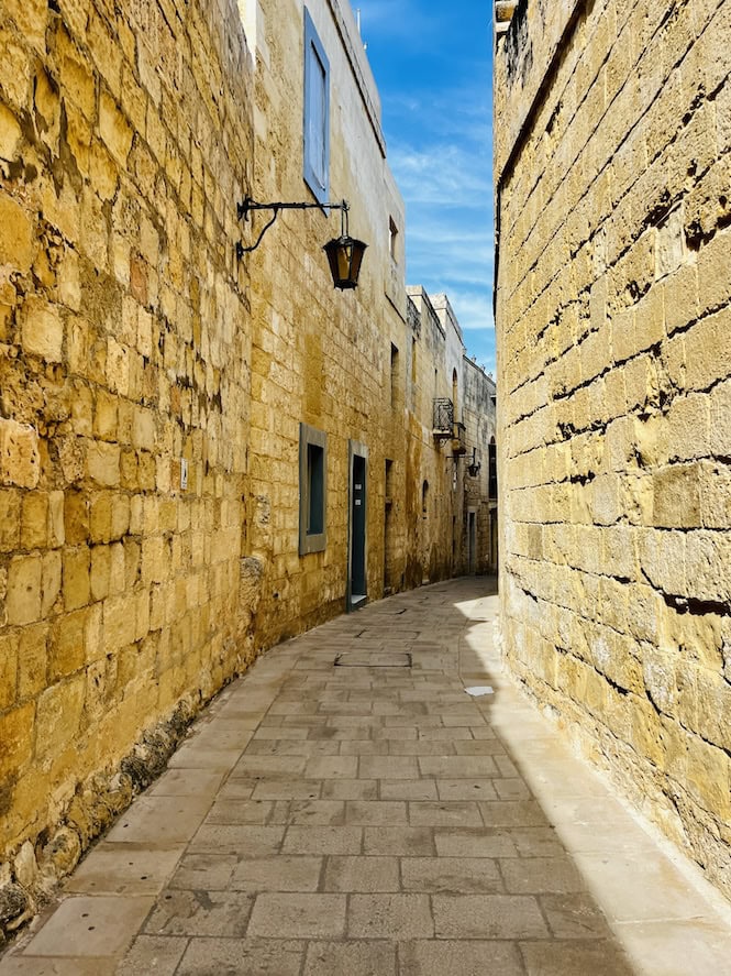 Mdina's narrow and winding street, creating an intimate and timeless atmosphere that feels like stepping back into the medieval era. Mdina is one of Malta's top tourist attractions, offering unique charm and serenity.