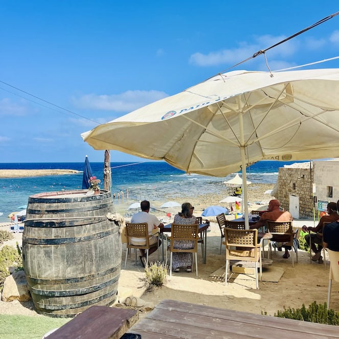 Enjoy local refreshments under the shade at Xwejni Bay's beachside kiosk in Gozo.