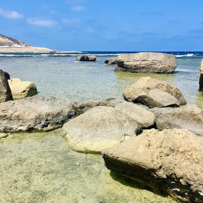 Rocky shoreline and crystal clear waters of Xwejni Bay in Gozo