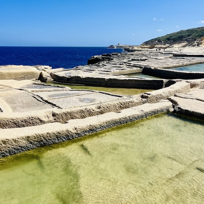 The unique salt pans of Gozo, Malta, filled with seawater in March, creating a picturesque landscape.