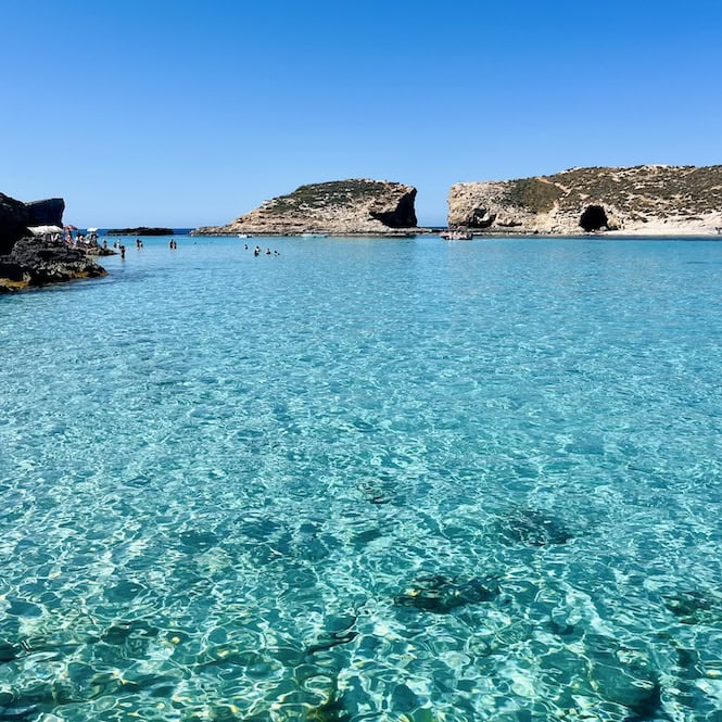 Crystal clear turquoise waters of the Blue Lagoon in Comino, Malta, perfect for swimming even in March